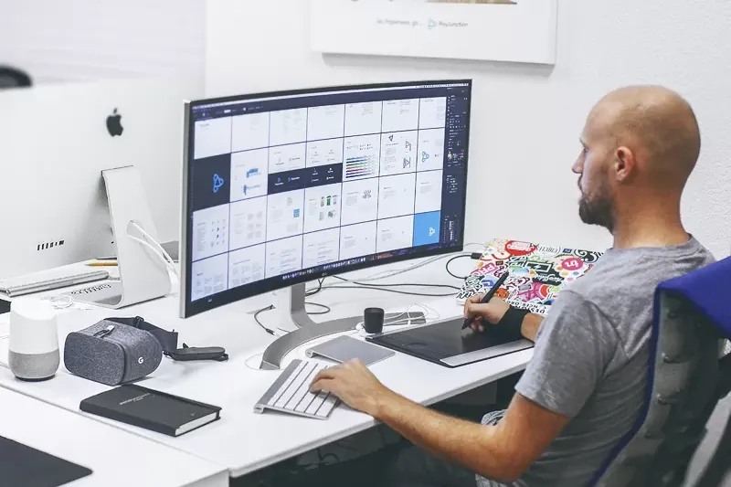 A specialist working with data in front of a computer screen